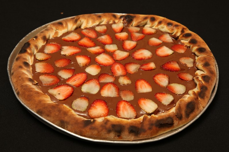 Pizza Nutella com morangos é oferecida pela Vinis Pizzaria; a Vinis fica na Rua Balbina de Matos, 1462, com funcionamento todos os dias, das 19h às 23h. O telefone é (67) 3426-8864.